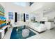 Open-concept living space with white sectional, glass table, TV, and dining area with lots of natural light at 2209 Crofton Ave, Davenport, FL 33837