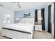 A spacious main bedroom with a king bed, accent wall, and carpeted floors at 2209 Crofton Ave, Davenport, FL 33837
