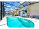 Relaxing screened-in pool area with ample seating, lounge chairs and outdoor dining space at 2209 Crofton Ave, Davenport, FL 33837
