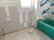 Unfinished bathroom with a bright green tub and updated plumbing fixtures at 2371 Zuni Road, St Cloud, FL 34771