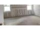 Spacious bedroom featuring a neutral palette and filled with natural light from two large windows at 2371 Zuni Road, St Cloud, FL 34771