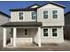 Charming two-story home with a covered front porch and neutral-colored siding at 2371 Zuni Road, St Cloud, FL 34771