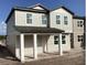 Inviting two-story home featuring a covered porch and light-colored exterior at 2371 Zuni Road, St Cloud, FL 34771