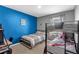 This cozy bedroom features a bunk bed, a desk, and a bright blue accent wall at 269 Ludisia Loop, Davenport, FL 33837