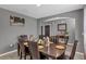 Spacious dining room with a dark wood table, leather chairs, and elegant decor at 269 Ludisia Loop, Davenport, FL 33837