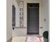 Inviting front entrance featuring a stylish gray door and a decorative 'HOME' sign at 269 Ludisia Loop, Davenport, FL 33837
