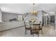 Open-concept living space with dining table, sofa, and neutral decor, creating a welcoming atmosphere at 269 Ludisia Loop, Davenport, FL 33837