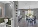 Bright living area featuring modern decor, an adjacent dining space, and convenient access to the powder room at 269 Ludisia Loop, Davenport, FL 33837