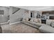 Comfortable living room featuring a large sectional sofa, neutral decor, and an open view to the kitchen and dining area at 269 Ludisia Loop, Davenport, FL 33837