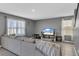 Comfortable living room with a large sectional sofa, TV, and neutral color scheme at 269 Ludisia Loop, Davenport, FL 33837