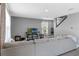 Spacious living room with a large sectional sofa, neutral walls, and a view of the staircase to the upper level at 269 Ludisia Loop, Davenport, FL 33837