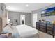 Cozy primary bedroom with a view of the attached bathroom, carpeted floors, neutral tones, and modern furniture at 269 Ludisia Loop, Davenport, FL 33837