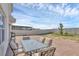 Back patio with brick pavers, outdoor seating, a partial view of the white fenced backyard at 269 Ludisia Loop, Davenport, FL 33837