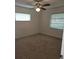 Bedroom with neutral carpet, two windows, and ceiling fan, making this space feel open and airy at 2817 Fitzooth Dr, Winter Park, FL 32792