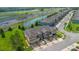 Aerial view of modern townhomes alongside a highway and water feature in a sunny neighborhood at 2936 Econ Landing Blvd, Orlando, FL 32825