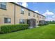 Townhome backyard featuring a lush lawn, privacy landscaping, and screened patios at 2936 Econ Landing Blvd, Orlando, FL 32825