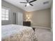 Bright bedroom with neutral walls, carpeted floors, and a ceiling fan at 2936 Econ Landing Blvd, Orlando, FL 32825
