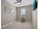 Bedroom with neutral carpet, a ceiling fan, and a television mounted on the wall at 2936 Econ Landing Blvd, Orlando, FL 32825