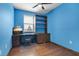 Bedroom featuring wood-look floors, built-in shelves and a window with lots of natural light at 2936 Econ Landing Blvd, Orlando, FL 32825