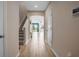 Inviting foyer with hardwood floors, staircase, and open floor plan with bright natural light at 2936 Econ Landing Blvd, Orlando, FL 32825