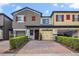 Charming townhomes feature brick driveways, attached garages, and eye-catching red shutters at 2936 Econ Landing Blvd, Orlando, FL 32825
