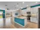 Stylish kitchen with a center island, modern white cabinets, and stainless steel appliances at 2936 Econ Landing Blvd, Orlando, FL 32825