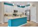 Bright kitchen boasts white cabinetry, a central island, and sleek stainless steel appliances at 2936 Econ Landing Blvd, Orlando, FL 32825