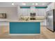 Modern kitchen features white cabinets, a central island, and stainless steel appliances at 2936 Econ Landing Blvd, Orlando, FL 32825