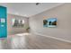 Inviting living room with wood-look tile flooring and large window at 2936 Econ Landing Blvd, Orlando, FL 32825