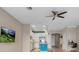 Open-concept living space with view of kitchen, desk space, and modern furnishings at 2936 Econ Landing Blvd, Orlando, FL 32825