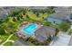 Aerial view of an inground pool with a sun bathing deck and lounge chairs surrounded by grass and apartment buildings at 2936 Econ Landing Blvd, Orlando, FL 32825