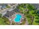 Community outdoor pool surrounded by sun bathing deck, cabana, playground, and lush green landscaping at 2936 Econ Landing Blvd, Orlando, FL 32825