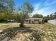 Inviting single-story home with a well-kept lawn and mature landscaping set against a clear blue sky at 300 Avenue E Se, Winter Haven, FL 33880