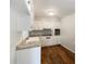 Functional kitchen featuring white cabinetry, modern appliances, and wood-look flooring providing a clean and efficient space at 300 Avenue E Se, Winter Haven, FL 33880