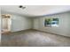 Living room with carpet, a window, and a view to the home across the street at 300 Avenue E Se, Winter Haven, FL 33880