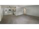 Spacious living room showing the entry, kitchen and backyard access with large windows at 300 Avenue E Se, Winter Haven, FL 33880