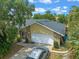 An elevated view of the home showing the front yard, two car garage, driveway, and landscaped yard at 3362 Partridge St, Deltona, FL 32738
