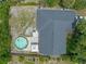 Aerial view of backyard featuring pool, patio area, landscaping, and fenced yard, ideal for relaxation and entertainment at 3362 Partridge St, Deltona, FL 32738