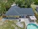 Aerial view of backyard featuring a patio, pool, landscaping, and well-maintained lawn for outdoor living at 3362 Partridge St, Deltona, FL 32738