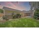 Exterior shot of a home's backyard, showcasing well-maintained lawn and exterior features at 3362 Partridge St, Deltona, FL 32738