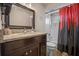 This bathroom has granite countertops, a dark wood vanity, a large mirror, and a shower with a tub at 3362 Partridge St, Deltona, FL 32738