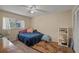 A bedroom with carpet flooring, a ceiling fan, a window, and a bed at 3362 Partridge St, Deltona, FL 32738