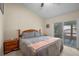 Cozy bedroom featuring wood furniture and a sliding glass door at 3362 Partridge St, Deltona, FL 32738