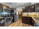 Bright kitchen with stainless steel appliances, granite counters, and dark wood cabinets at 3362 Partridge St, Deltona, FL 32738