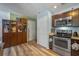 Spacious kitchen featuring stainless steel appliances, wood floors, and dark wood cabinets at 3362 Partridge St, Deltona, FL 32738