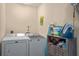 This is a laundry room that includes a washer, a dryer, and storage space at 3362 Partridge St, Deltona, FL 32738