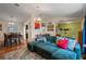 Open living space with wood floors, a comfortable sofa, adjacent to a breakfast nook and adjacent to the foyer at 3362 Partridge St, Deltona, FL 32738