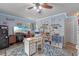 Bright office featuring a ceiling fan, hardwood floors, and a built-in desk at 3362 Partridge St, Deltona, FL 32738