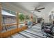 A long sunroom with striped carpet, many windows, and office furniture at 3362 Partridge St, Deltona, FL 32738