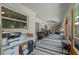 A long sunroom with striped carpet, many windows, and office furniture at 3362 Partridge St, Deltona, FL 32738